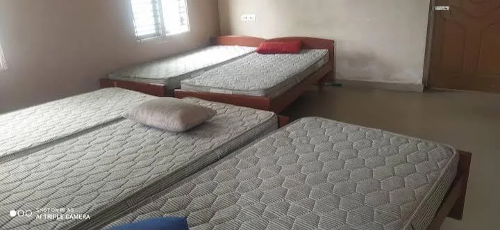 Shared room with several neatly arranged beds