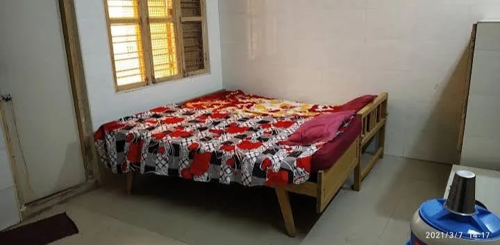 Simple room with two beds and a window